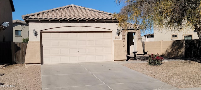 mediterranean / spanish-style home with a garage