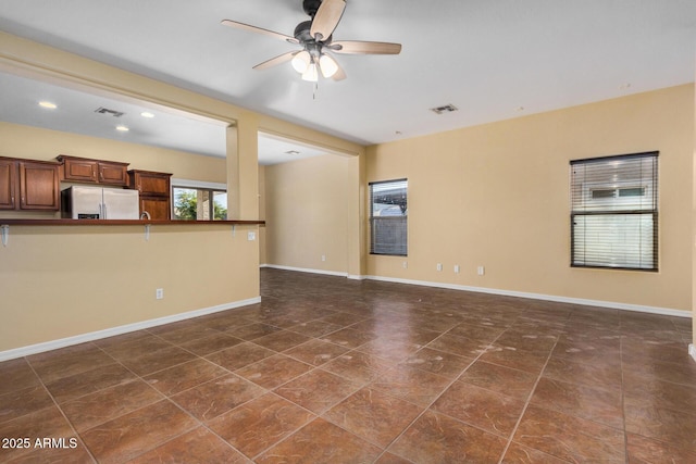 unfurnished living room featuring ceiling fan