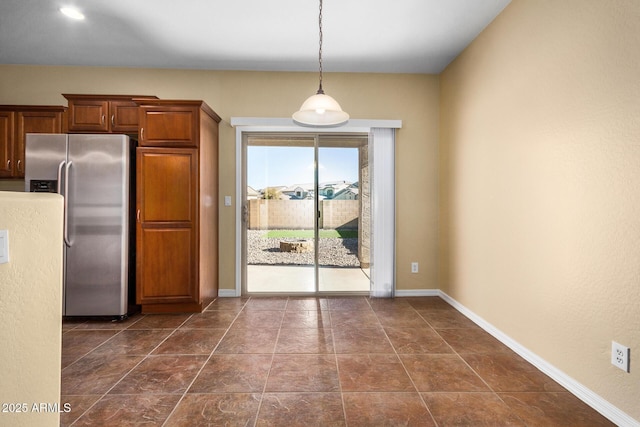 kitchen featuring decorative light fixtures and stainless steel fridge with ice dispenser