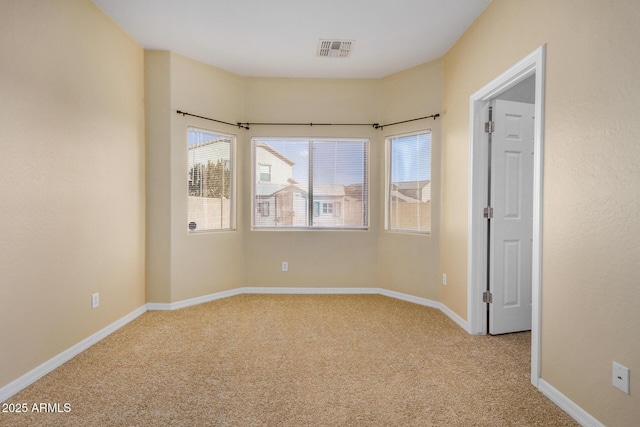 empty room with light colored carpet