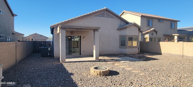 rear view of house featuring cooling unit and a patio