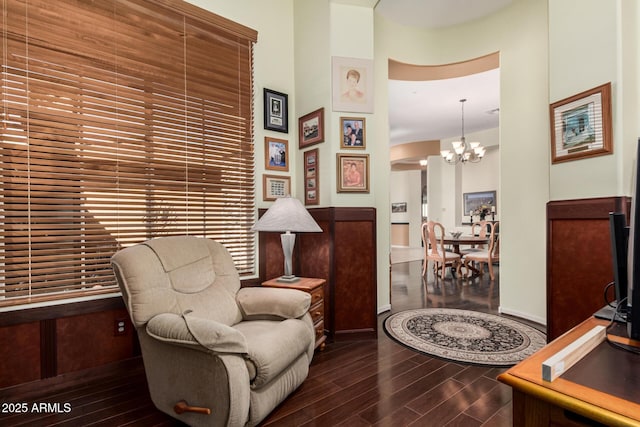 sitting room with wood finished floors and a notable chandelier