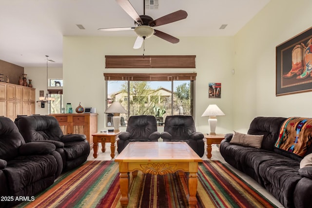 living area featuring a ceiling fan and visible vents