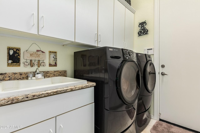 clothes washing area with cabinet space, washing machine and dryer, light tile patterned floors, and a sink