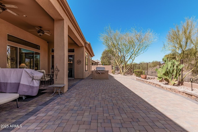 view of patio featuring a fenced backyard, a ceiling fan, and a grill