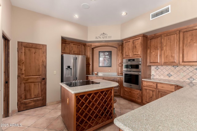 10657 E Cloudview Ave, Gold Canyon, AZ 85118 - kitchen featuring decorative backsplash, visible vents, light tile patterned floors, light countertops, and stainless steel appliances