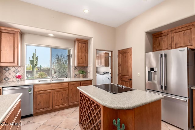 10657 E Cloudview Ave, Gold Canyon, AZ 85118 - kitchen featuring decorative backsplash, a sink, light countertops, stainless steel appliances, and washer and clothes dryer