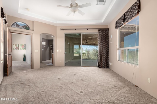 10657 E Cloudview Ave, Gold Canyon, AZ 85118 - carpeted empty room featuring arched walkways, ceiling fan, a raised ceiling, and visible vents