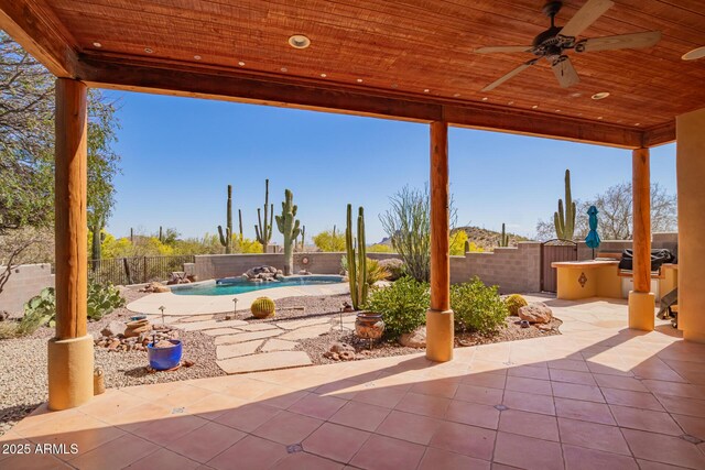 10657 E Cloudview Ave, Gold Canyon, AZ 85118 - view of patio featuring exterior kitchen, a fenced in pool, a ceiling fan, and a fenced backyard