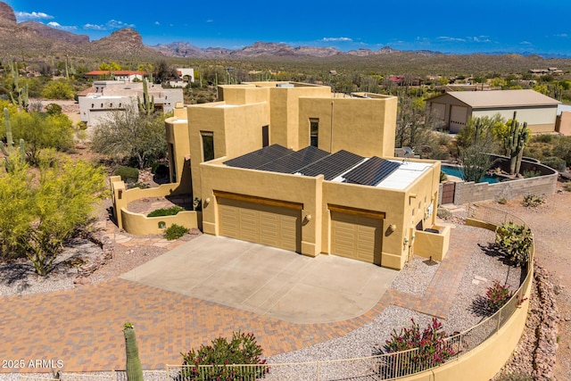 10657 E Cloudview Ave, Gold Canyon, AZ 85118 - pueblo-style house featuring concrete driveway, a garage, a mountain view, and stucco siding
