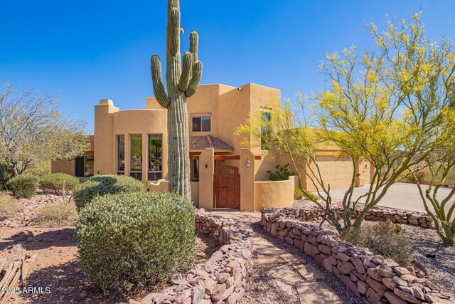 10657 E Cloudview Ave, Gold Canyon, AZ 85118 - pueblo-style house with a garage, stucco siding, a tiled roof, and concrete driveway