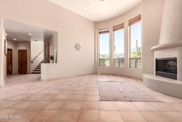 10657 E Cloudview Ave, Gold Canyon, AZ 85118 - unfurnished living room featuring stairs, tile patterned floors, baseboards, and a fireplace