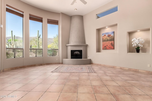 10657 E Cloudview Ave, Gold Canyon, AZ 85118 - unfurnished living room with light tile patterned floors, a large fireplace, and ceiling fan