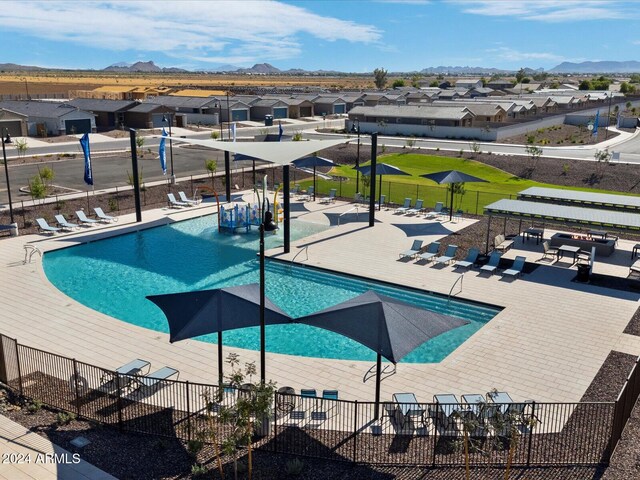 view of pool featuring a mountain view and a patio