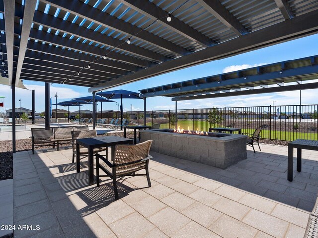 view of patio featuring a pergola and an outdoor fire pit