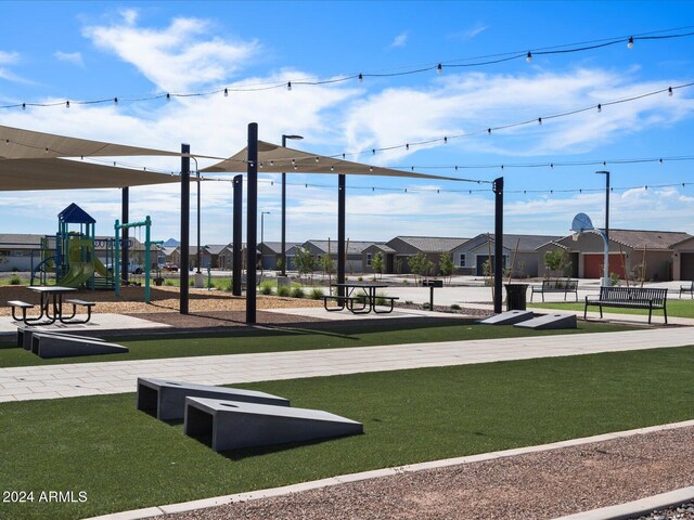 view of home's community featuring a lawn and a playground