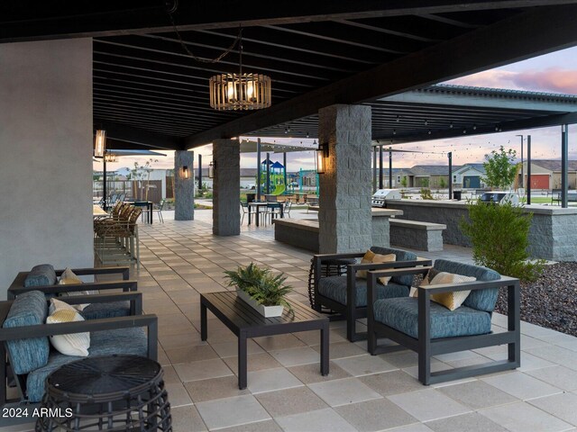 patio terrace at dusk featuring a bar