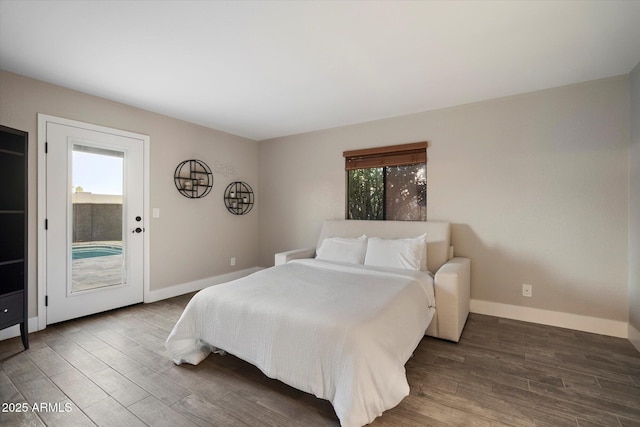 bedroom featuring access to exterior, wood finished floors, and baseboards