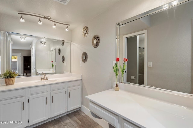 full bath with wood finished floors and vanity