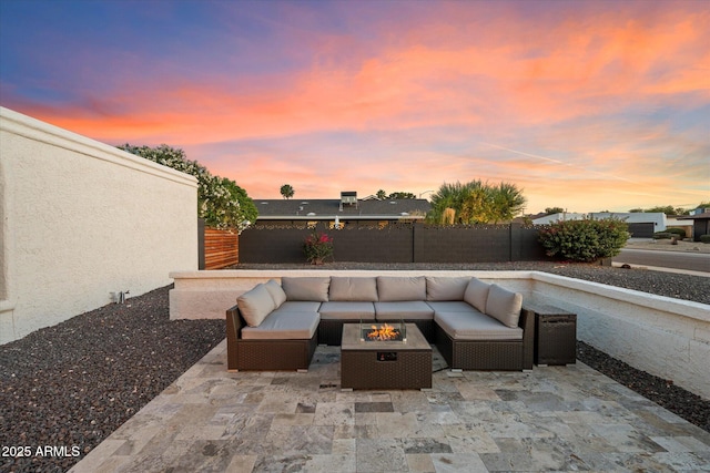 view of patio / terrace with an outdoor living space with a fire pit and a fenced backyard