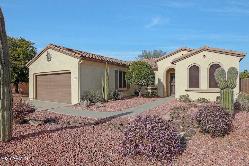 mediterranean / spanish-style home with a garage