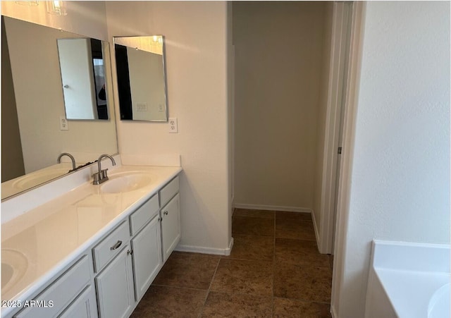 bathroom featuring vanity, tile patterned flooring, and a bath