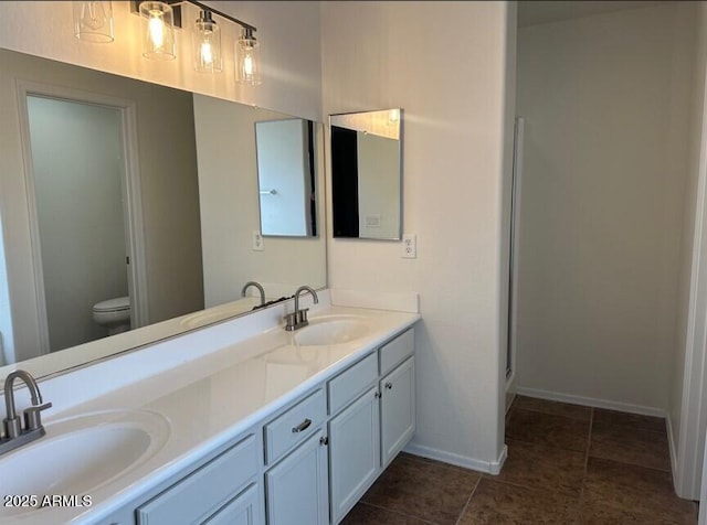 bathroom with vanity, tile patterned flooring, and toilet