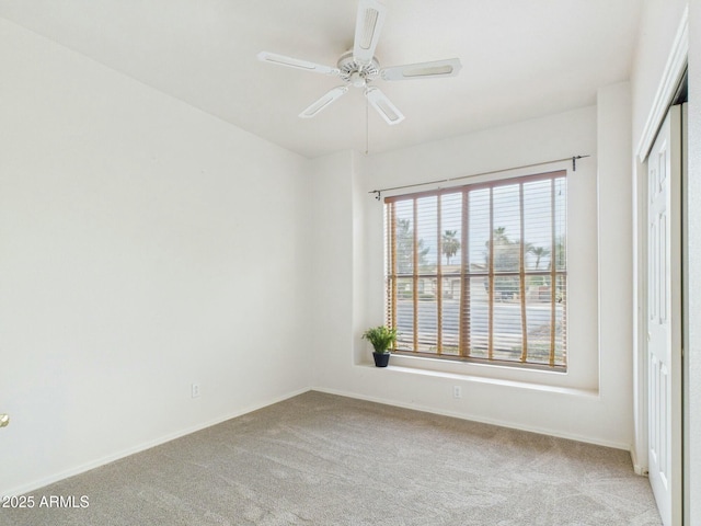 unfurnished room with carpet floors, ceiling fan, and baseboards