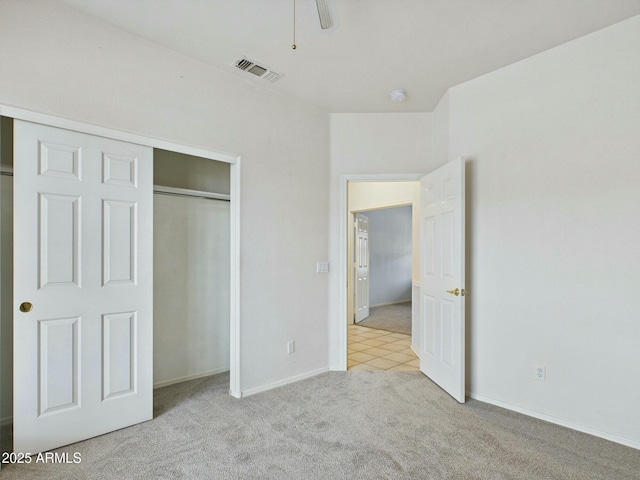 unfurnished bedroom with baseboards, a closet, visible vents, and carpet flooring