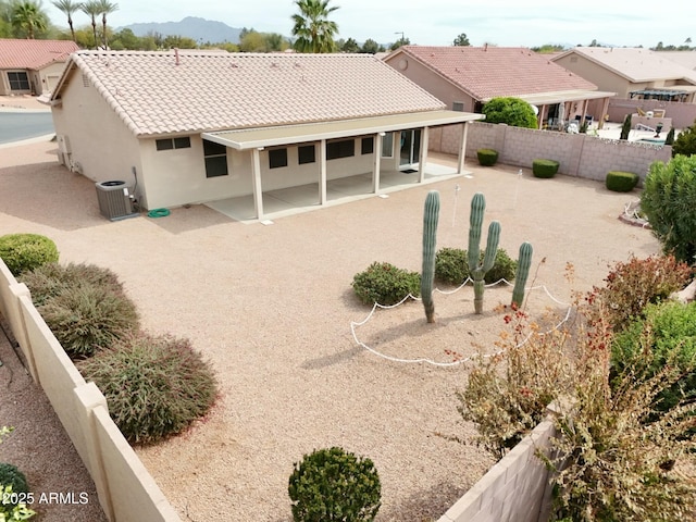 back of property featuring a patio, a fenced backyard, cooling unit, a tiled roof, and stucco siding