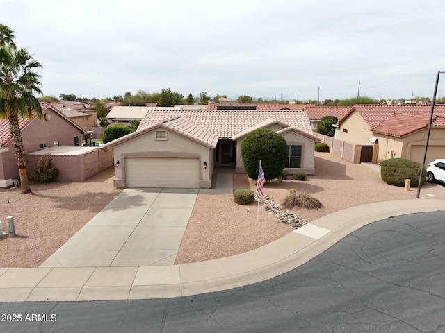 view of front of property featuring a garage, concrete driveway, a tiled roof, fence, and stucco siding