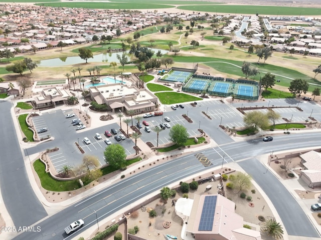 aerial view featuring golf course view, a water view, and a residential view