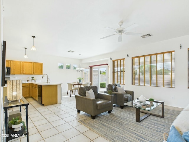 living room featuring ceiling fan with notable chandelier, visible vents, and light tile patterned floors