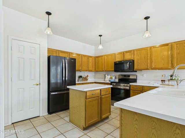 kitchen featuring stainless steel electric range oven, freestanding refrigerator, light countertops, black microwave, and a sink