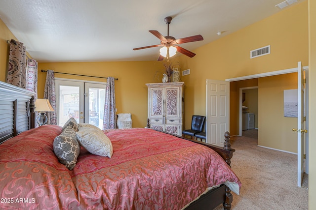 bedroom featuring lofted ceiling, visible vents, carpet floors, and washing machine and clothes dryer