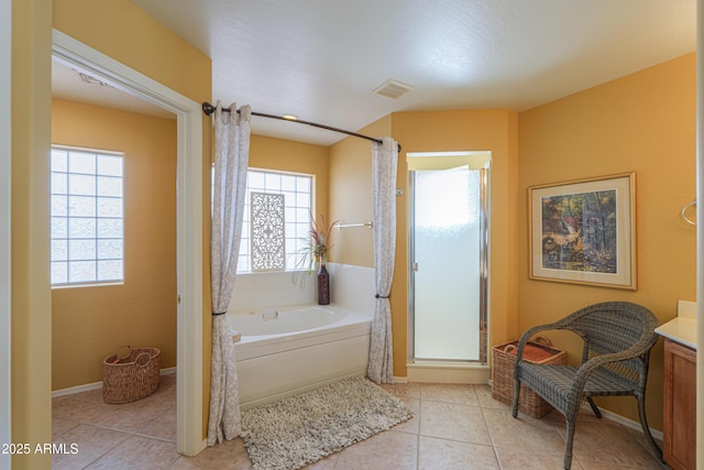 full bathroom with visible vents, a shower stall, a garden tub, and a healthy amount of sunlight