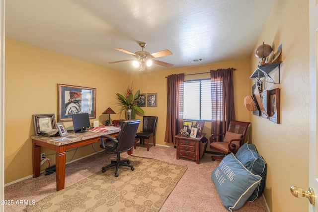 office space with visible vents, ceiling fan, baseboards, and carpet floors