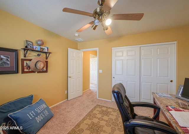 office space featuring light carpet, visible vents, ceiling fan, and baseboards