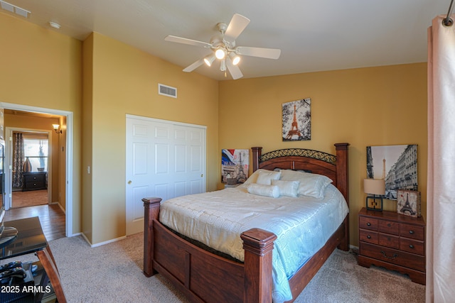 carpeted bedroom featuring visible vents, ceiling fan, and baseboards