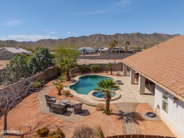 view of swimming pool with a patio area, a fenced in pool, a mountain view, and a fenced backyard