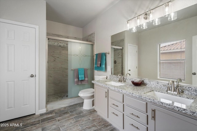 10551 W Jessie Ln, Peoria, AZ 85383 - bathroom with wood finish floors, a sink, toilet, and a shower stall