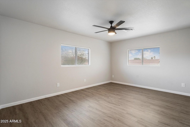 10551 W Jessie Ln, Peoria, AZ 85383 - empty room with a healthy amount of sunlight, ceiling fan, and wood finished floors