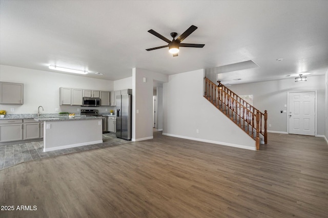 10551 W Jessie Ln, Peoria, AZ 85383 - kitchen with wood finished floors, a ceiling fan, appliances with stainless steel finishes, a sink, and open floor plan