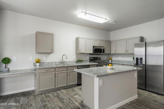 10551 W Jessie Ln, Peoria, AZ 85383 - kitchen featuring visible vents, wood finish floors, a sink, and stainless steel appliances
