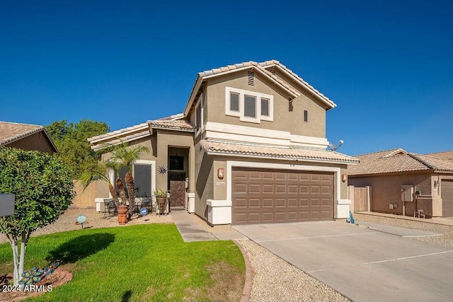 mediterranean / spanish-style house with a garage and a front lawn