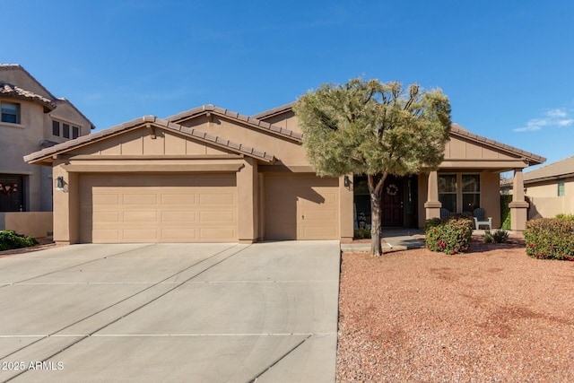 view of front facade with a garage, concrete driveway, and stucco siding