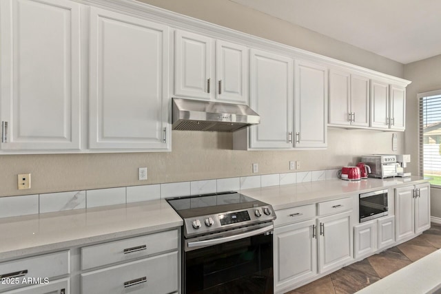 kitchen featuring stainless steel appliances, white cabinetry, and exhaust hood