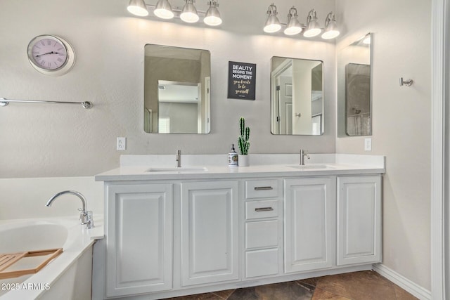 bathroom with vanity and a bath