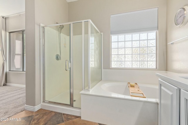 bathroom with separate shower and tub and vanity