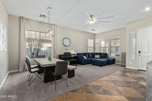 dining room with ceiling fan with notable chandelier